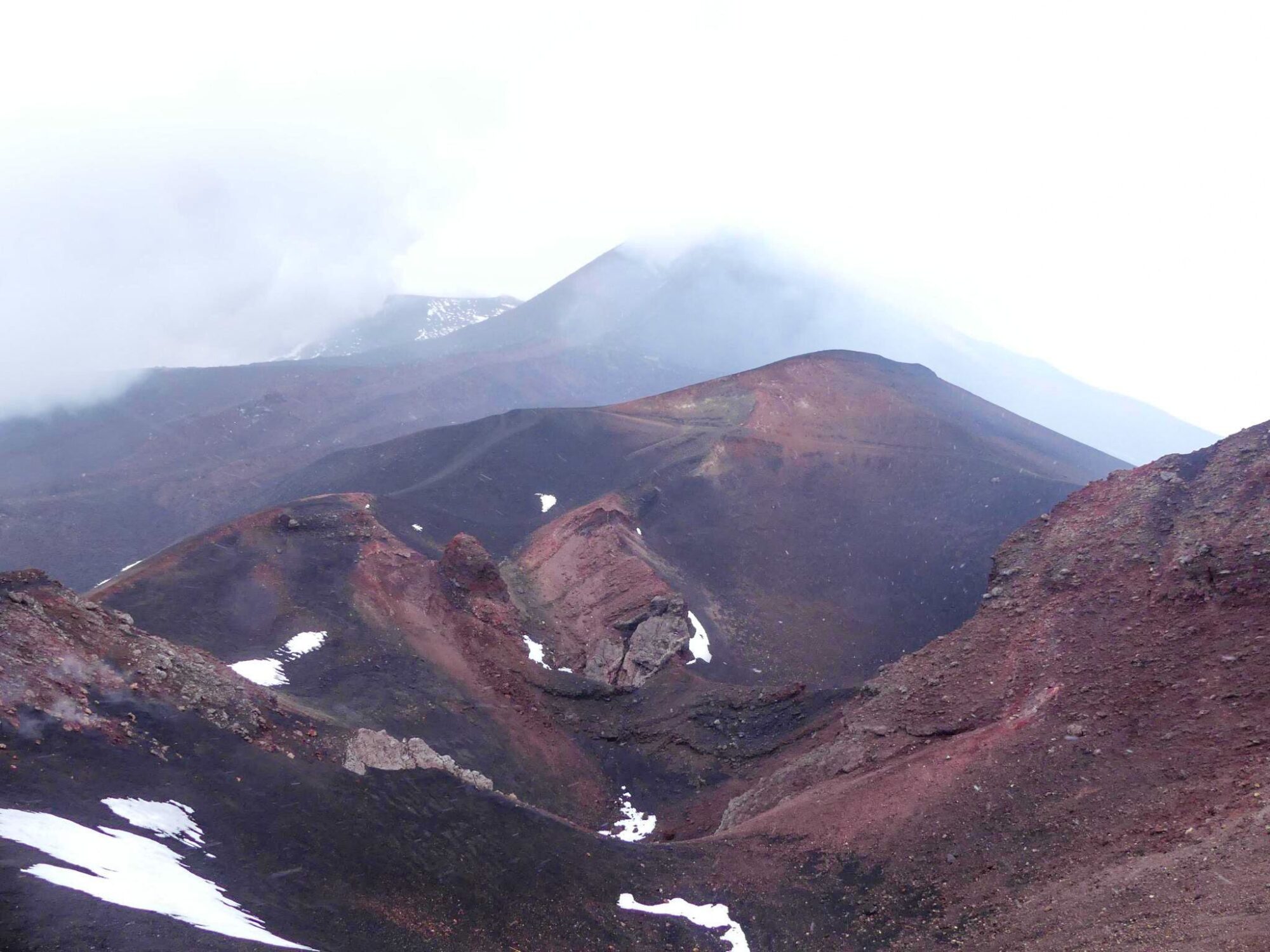 Mountainous and lunar landscapes. The peaks are hidden behind the mountains