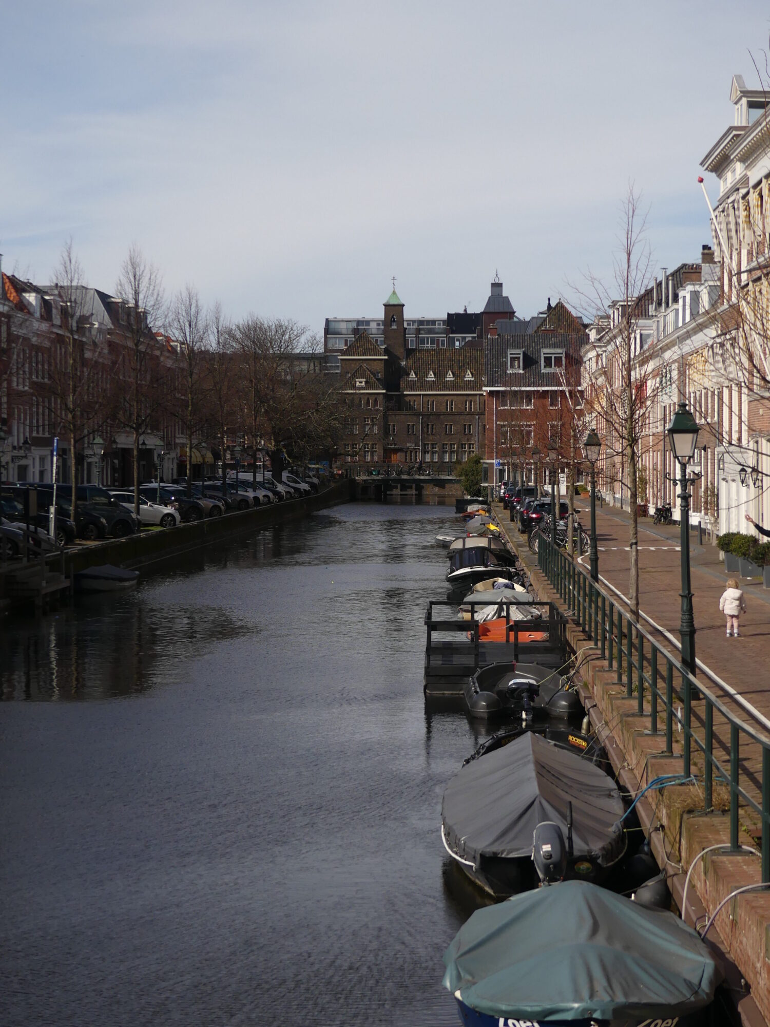 Canal running through the Hague, lined with small houses.